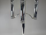 a silver candle holder with three candles on it