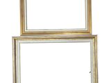 two gold frames on a white wall with a white background