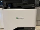 the printer is sitting on the floor in front of the other printers
