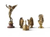 a lot of gold figurines sitting on a white surface