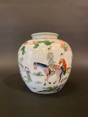 a white vase with a picture of a man riding a horse