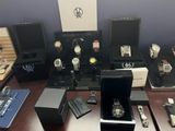 a lot of watches that are on display on the table