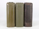 three old metal cans sitting next to each other on a white surface