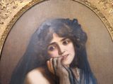 painting of a woman in a blue dress with her hand on her chin