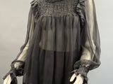 an image of a mannequin wearing a black top and skirt