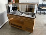 a glass case that is sitting on top of a wooden cart