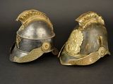 pair of silver and gold helmets on a black background