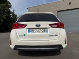 the rear end of a white car parked in a parking lot