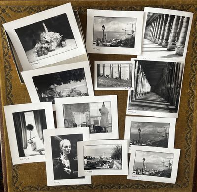 black and white photograph of a collection of photographs on a table