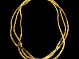 an image of a gold necklace on a black background