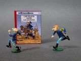 two figurines of a man and a woman playing a game of baseball