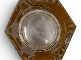 a glass ashtray with a picture of a man on it