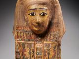 a wooden head of a woman with an open mouth