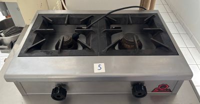 a gas stove that is sitting in a kitchen