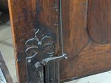 a close up of a door handle on a wooden door