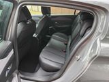 the back seats of a car with the door open and the driver ' s seat down