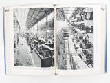 an open book with black and white pictures of cars in a factory