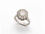 a close up of a diamond ring on a white background