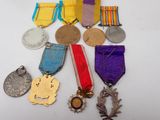 several medals and medals are laid out on a white surface