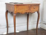 a small wooden table with a drawer on top of it