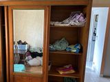 a large wooden cabinet with a mirror on top of it