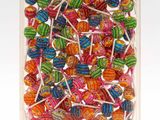 colorful lollipops in a clear box on a white background