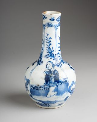 a blue and white vase sitting on a table