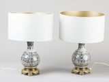 pair of silver and gold table lamps with white lampshads