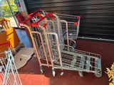 several shopping carts are lined up in front of a garage door