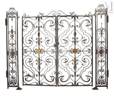 a close up of a metal gate with a flower design on it