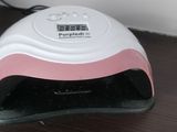 a pink and white nail dryer sitting on a table