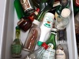 many bottles of alcohol in a box on a table
