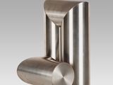 a close up of a stainless steel object on a white background