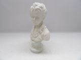 a white busturine of a woman on a table