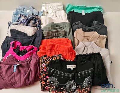 a lot of clothes that are sitting on a table