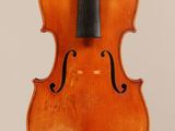 an old violin with a bow hanging from the back