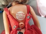a doll that has a sticker on it ' s back