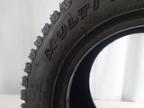 tire tread of a truck with a tire on it on a white surface
