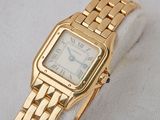 an image of a gold wrist watch with roman numerals on it