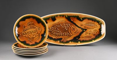 several plates with fish designs are stacked on top of each other