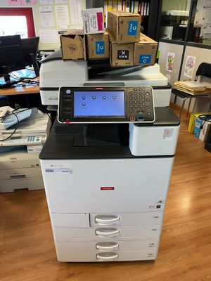 a printer sitting on top of a desk in an office
