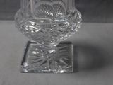 a clear glass vase with a flower inside of it