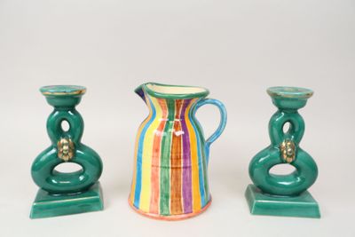 three different colored vases sitting next to each other on a table