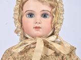a doll that is wearing a bonnet and a dress