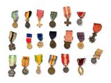 an assortment of medals and medals are displayed on a white surface