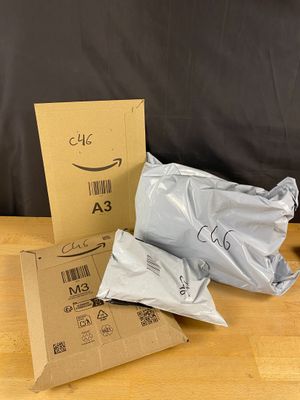 three bags of food sitting on a table next to a cardboard box