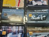 many cards of different cars on a table