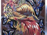motif de point de croix représentant un oiseau coloré entouré de papillons