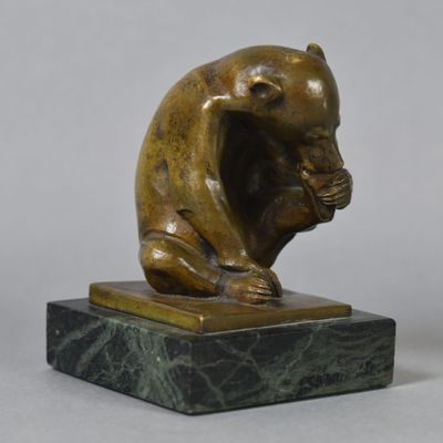 bronze sculpture of a monkey sitting on a marble base