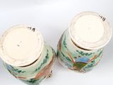 two vases that are sitting on a white surface